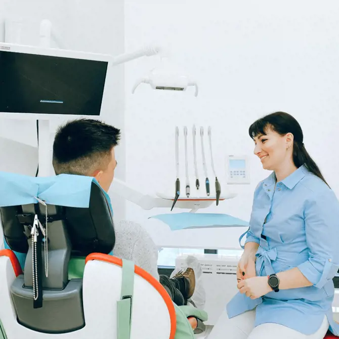 Dentist and client speaking in a hygenic office