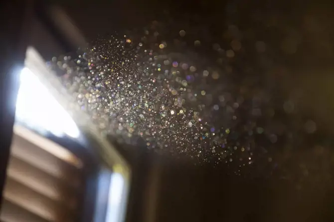 Close up of dust particles shining through the window